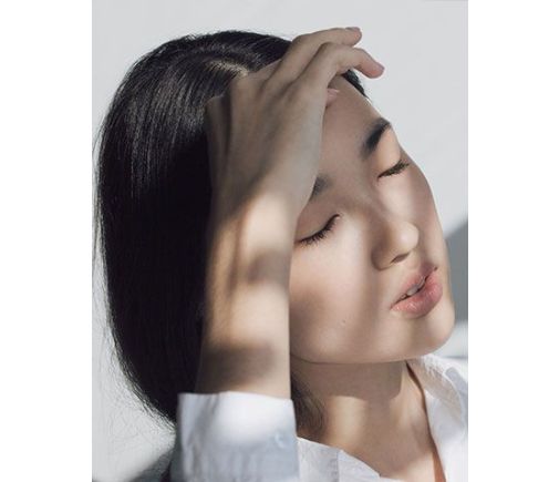 Woman holding her forehead in pain.