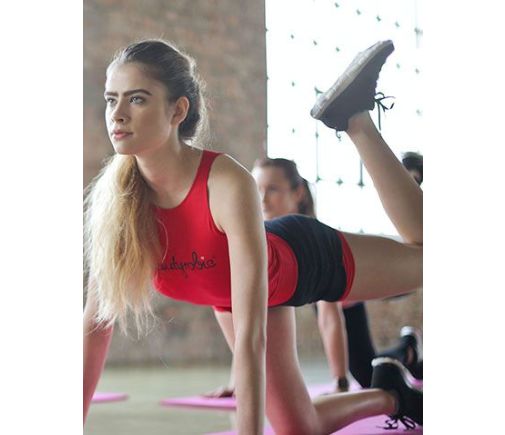 Group of women on yoga mats working out together.