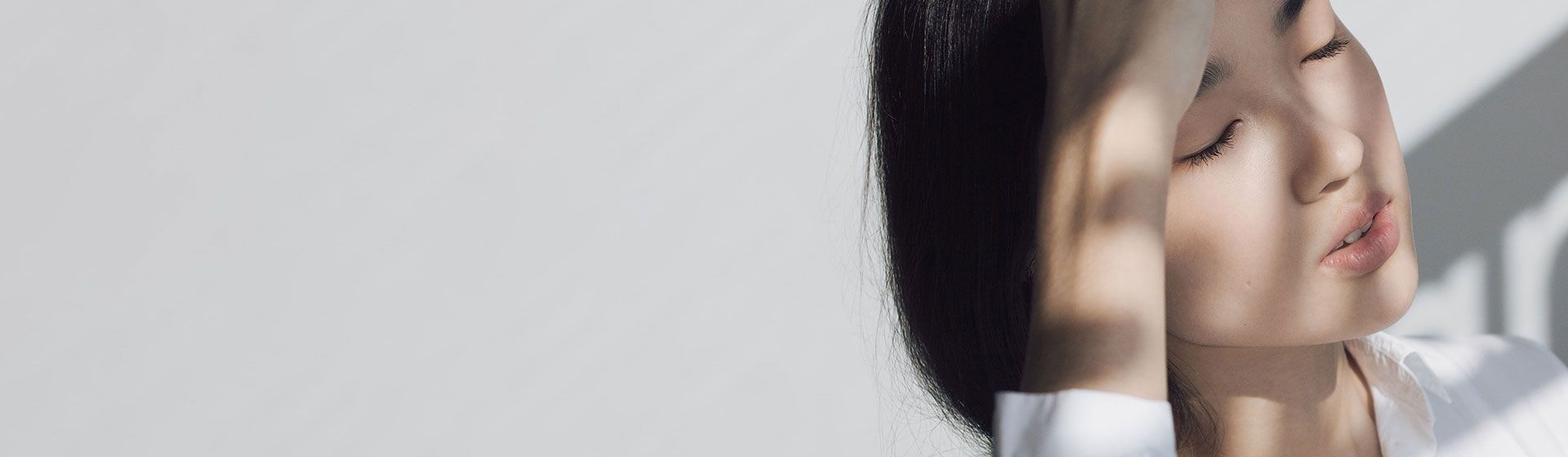 Woman holding her forehead in pain.